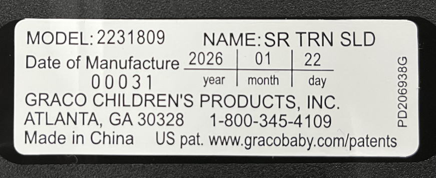 Example label showing model number, date of manufacture, and serial number on the SnugRide Turn and Slide base